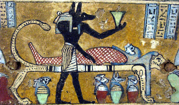 Anubis standing over mummy