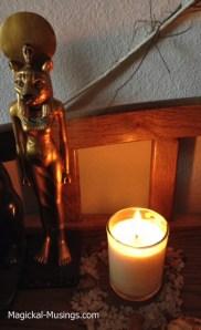 A Metatron candle burning in front of my statue of Sekhmet.