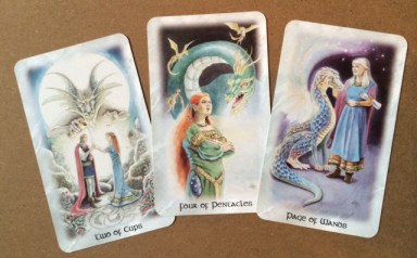 The 2 of Cups, 4 of Pentacles & Page of Wands from The Celtic Dragon Tarot by Lisa Hunt.